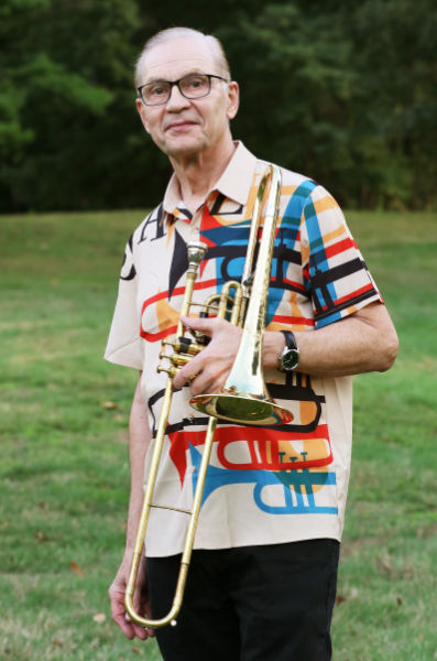 Scott Reeves outdoors holding an alto valve trombone