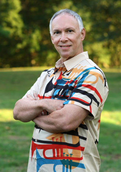 Todd Beaney standing outdoors with crossed arms