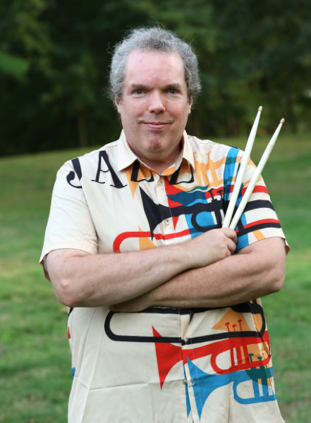 Wayne Dunton outdoors holding drum sticks