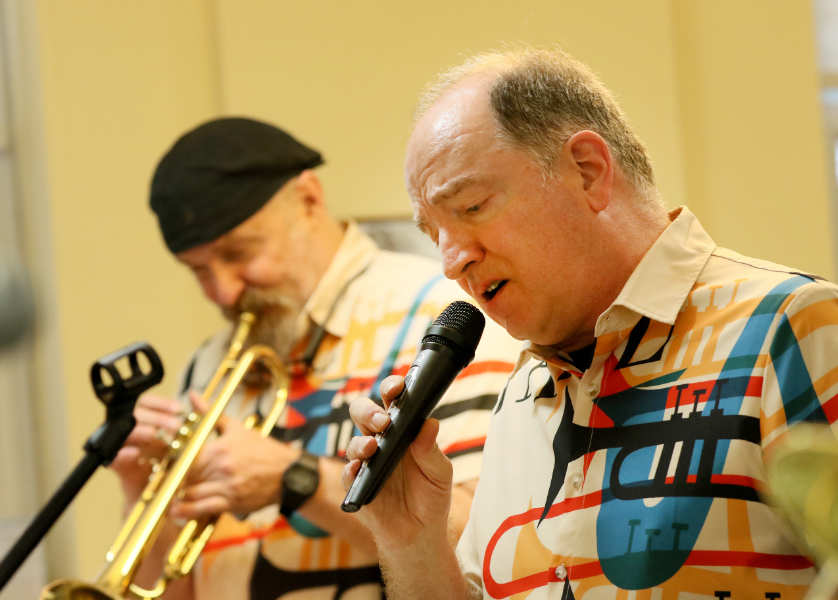 Bill Ash sings while Jon Leonard plays trumpet behind him